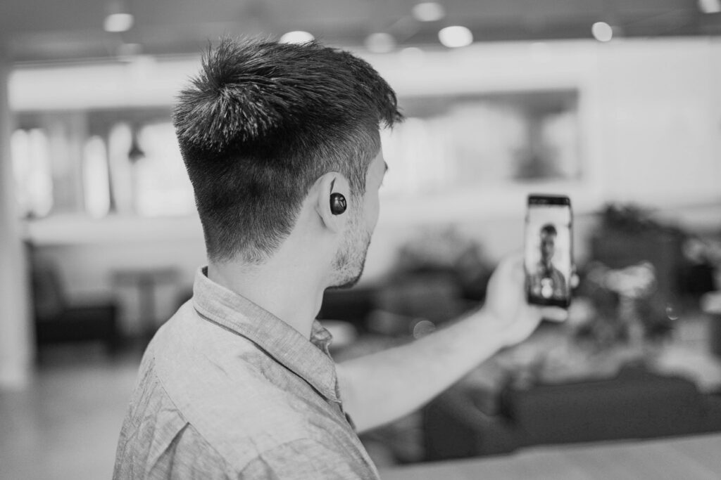 Black and white photo of a guy making short-form video