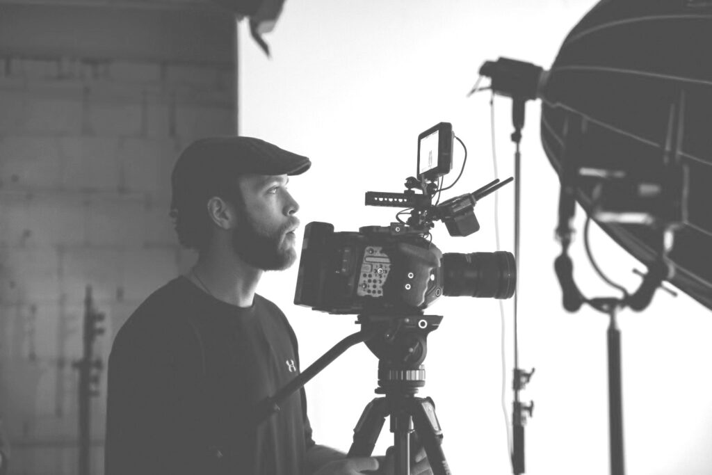 Black and white photo of a videographer with camera